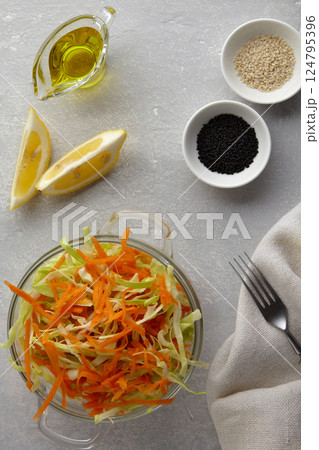 summer cabbage and carrot salad with sesame and caraway seeds with lemon and olive oil 124795396