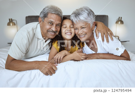 Love, bonding and mature people with child bonding while relaxing on the bed at home. Grandmother, grandfather and grandchild resting with affection and bond in their house bedroom for loving oomfort Love, bonding and mature people with child bonding while relaxing on the bed at home. Grandmother, grandfather and grandchild resting with affection and bond in their house bedroom for loving oomfort 124795494