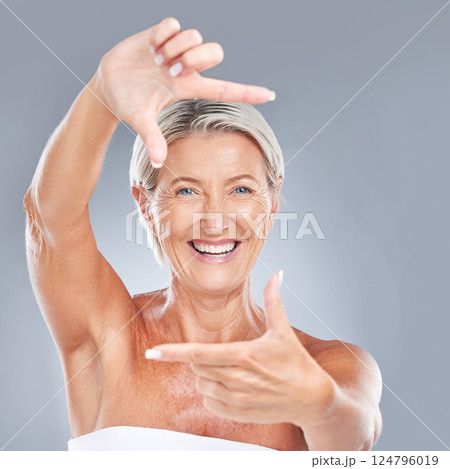 Picture hand face frame, happy and senior woman with a smile from skin wellness and beauty. Portrait of a elderly person model feeling happiness from skincare and anti aging cosmetic treatment 124796019