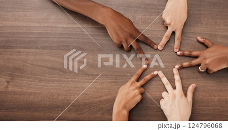 Hands, diversity and star shape on table for team building, community and peace gesture from above. People, friends or group with collaboration, creativity and teamwork for sign, or icon on a desk Hands, diversity and star shape on table for team building, community and peace gesture from above. People, friends or group with collaboration, creativity and teamwork for sign, or icon on a desk 124796068