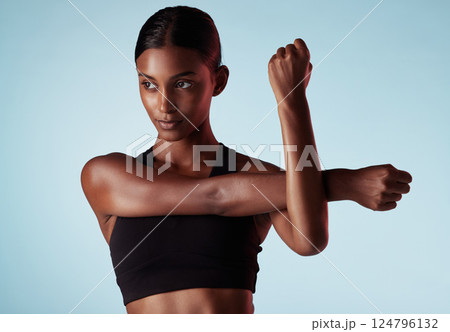 Fitness, studio and woman stretching shoulder and arms in a warm up to start training, workout and cardio exercise. Focus, wellness and healthy young sports girl relaxing her strong body muscles Fitness, studio and woman stretching shoulder and arms in a warm up to start training, workout and cardio exercise. Focus, wellness and healthy young sports girl relaxing her strong body muscles 124796132