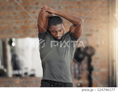 Exercise, stretch and man at gym for training, health and wellness against a brick wall background mockup. Fitness, stretching and sport guy with relax mindset before workout, cardio and performance 124796177