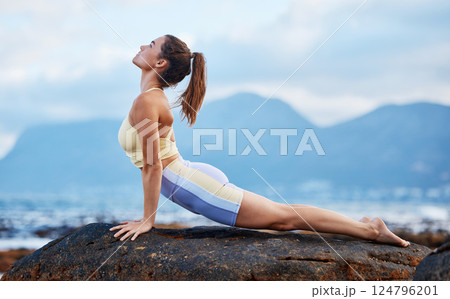 Woman, rock or beach yoga fitness in relax workout, training and exercise in Australia for mental health, wellness or mindset energy. Zen, calm or peace yogi stretching in chakra pilates by ocean sea 124796201