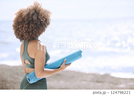 Black woman, yoga mat and enjoying ocean and view before zen, peaceful and relaxing exercise. A yogi and woman ready to meditate at beach. Nature, african american girl and meditation by sea Black woman, yoga mat and enjoying ocean and view before zen, peaceful and relaxing exercise. A yogi and woman ready to meditate at beach. Nature, african american girl and meditation by sea 124796221