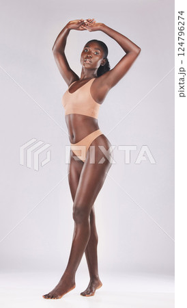 Beauty, body and underwear with a model black woman in studio on a gray background for a health lifestyle. Portrait, health and skincare with an attractive young female posing to promote natural care Beauty, body and underwear with a model black woman in studio on a gray background for a health lifestyle. Portrait, health and skincare with an attractive young female posing to promote natural care 124796274