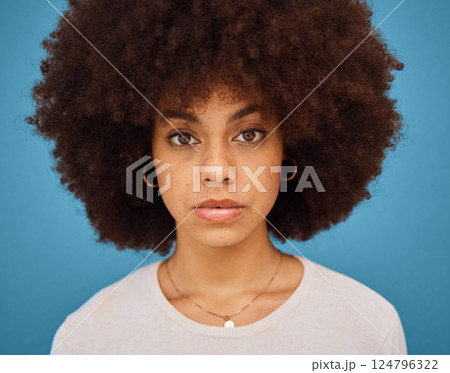 Black woman, natural hair and afro for skincare, hair care and beauty on a blue studio background. Face portrait or headshot of an African model posing for cosmetic, fashion and self care motivation 124796322