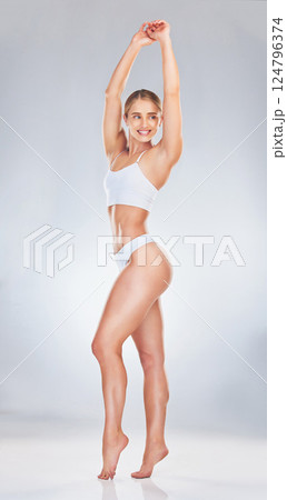 Body, underwear and beauty with a model woman in studio on a gray background to promote natural wellness. Fitness, exercise and health with an attractive young female inside to promote a healthy diet 124796374