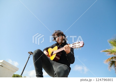 Man Plays Classical Guitar On A Day Stand In The Park Man Plays Classical Guitar On A Day Stand In The Park 124796801