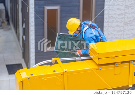 電柱上にあるカラスの巣を撤去した保守管理作業員 124797120