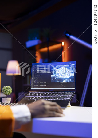 AI expert writes code on laptop in apartment office using Java programming languages. Artificial intelligence programmer remotely working on fixing database errors while working from home, close up AI expert writes code on laptop in apartment office using Java programming languages. Artificial intelligence programmer remotely working on fixing database errors while working from home, close up 124797142