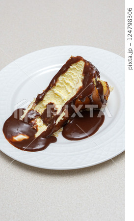 Delicious and Indulgent San Sebastian Cheesecake with Rich Chocolate ganache Topping for Dessert Lovers Delicious and Indulgent San Sebastian Cheesecake with Rich Chocolate ganache Topping for Dessert Lovers 124798306