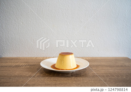 A sweet pudding served on a plate. Pudding is a popular dessert and snack. It tastes sweet, and comes in many flavors. 124798814