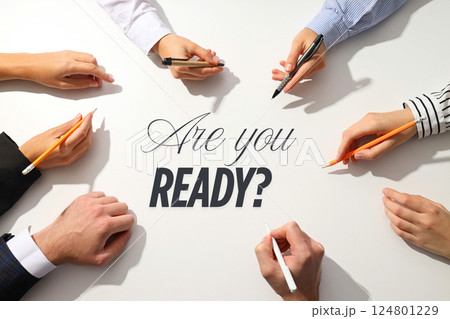 Job interview, Participants gather around a table, showing readiness to tackle job interview preparation with pens and determination to succeed 124801229