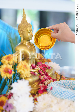 Happy Songkran festival day in Thailand or Thai Happy New Year. hand pouring water on golden Buddha statue with flowers and garland in. Holiday and culture concept Happy Songkran festival day in 124801777