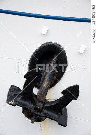 Detail of a ship's hull and anchor. Vertical orientation. Copy space. 124802462