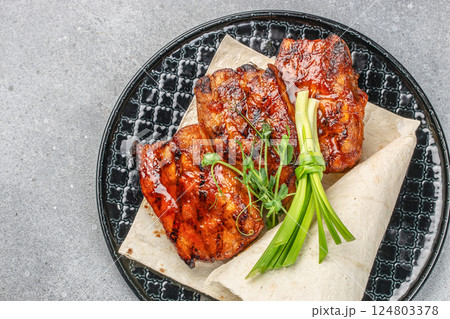 hot grilled spare ribs glazed in BBQ sauce. Food recipe background. Close up. top view 124803378