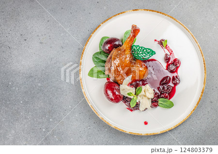 Roasted duck leg confit with sauce. Food recipe background. Close up. top view 124803379