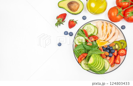Fresh green salad with grilled chicken fillet, tomatoes, avocado, lemon on light background. Diet Concept. Top view copy space, Fresh green salad with grilled chicken fillet, tomatoes, avocado, lemon on light background. Diet Concept. Top view copy space, 124803433
