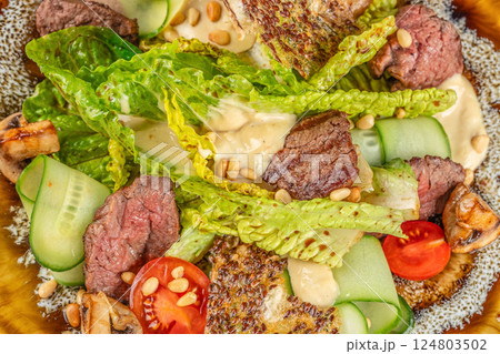 beef steak medium rare, fresh greens and vegetable salad. Food recipe background. Close up. top view beef steak medium rare, fresh greens and vegetable salad. Food recipe background. Close up. top view 124803502