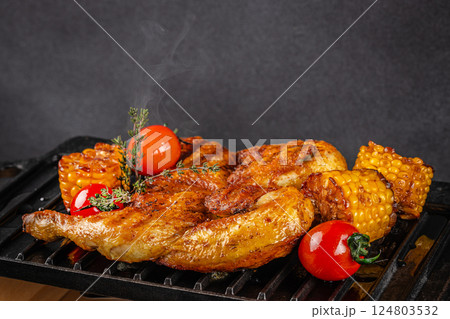 Hot Chicken Tobacco on grill on a dark background. copy space Hot Chicken Tobacco on grill on a dark background. copy space 124803532