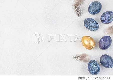 Festive Easter background. Easter eggs and flowers decorated on a light background. top view. copy space Festive Easter background. Easter eggs and flowers decorated on a light background. top view. copy space 124803553