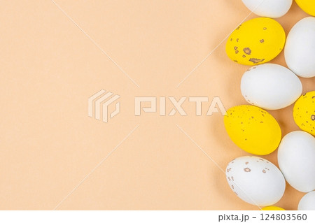 Small speckled multicolored chocolate eggs set on a beige background, top view. copy space Small speckled multicolored chocolate eggs set on a beige background, top view. copy space 124803560
