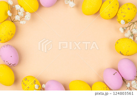 Small speckled multicolored chocolate eggs set on a beige background, top view. copy space Small speckled multicolored chocolate eggs set on a beige background, top view. copy space 124803561