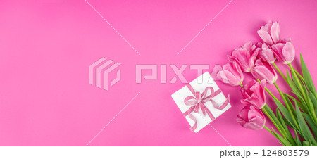 Greeting card background with tulip flowers bouquet, gift box with pink ribbon. Happy Mother Day. Long banner format. top view. copy space 124803579