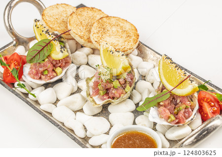 Raw Tuna tartar with avocado and sauce, Food recipe background. Close up. top view Raw Tuna tartar with avocado and sauce, Food recipe background. Close up. top view 124803625