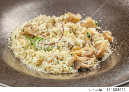 risotto with brown champignon mushrooms and white wine. dish of Italian cuisine risotto with brown champignon mushrooms and white wine. dish of Italian cuisine 124803631