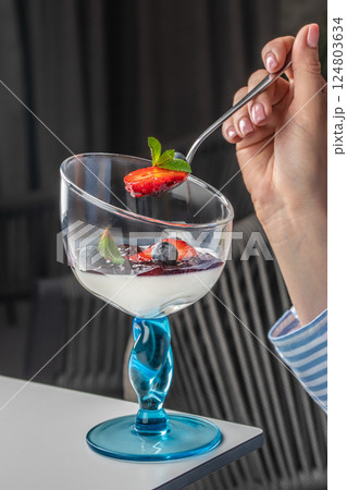 Italian dessert panna cotta in glass with strawberries 124803634