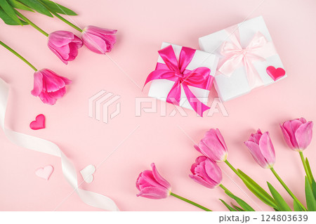 Frame made of gift boxes with ribbon beautiful tulips on pink background. happy mothers day, top view. copy space 124803639