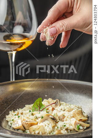 risotto with brown champignon mushrooms and white wine. dish of Italian cuisine risotto with brown champignon mushrooms and white wine. dish of Italian cuisine 124803704