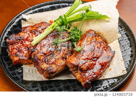 hot grilled spare ribs glazed in BBQ sauce. Food recipe background. Close up. top view hot grilled spare ribs glazed in BBQ sauce. Food recipe background. Close up. top view 124803710
