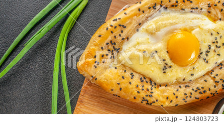 Khachapuri with egg on wooden background. Georgian cuisine. top view. copy space for text 124803723