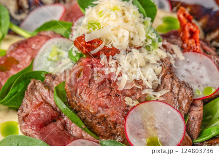 beef steak medium rare, fresh greens and vegetable salad. Food recipe background. Close up. top view 124803736