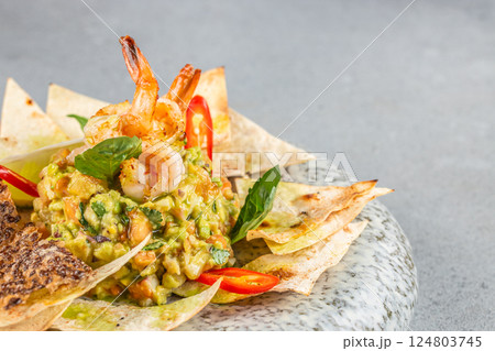 guacamole and shrimp served with crispy tortilla chips. Food recipe background. Close up guacamole and shrimp served with crispy tortilla chips. Food recipe background. Close up 124803745