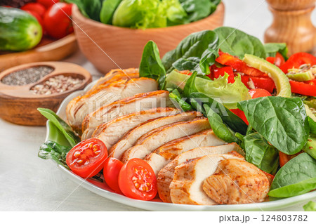 Roasted chicken breast, fillet and fresh vegetable salad. Food recipe background. Close up 124803782