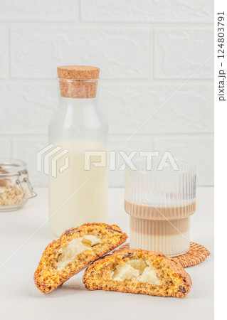 healthy homemade oat cookies with cheese filling, glass of latte on a light background. space for text 124803791