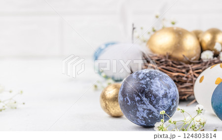 Colorful Easter eggs with spring blossom flowers on light background. Happy easter concept. copy space Colorful Easter eggs with spring blossom flowers on light background. Happy easter concept. copy space 124803814