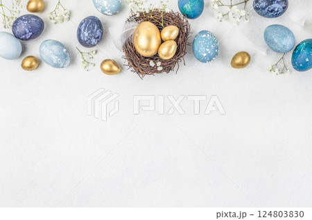 Easter eggs with blossoms spring flowers in a nest on a white background. Natural easter greeting card. top view. copy space 124803830