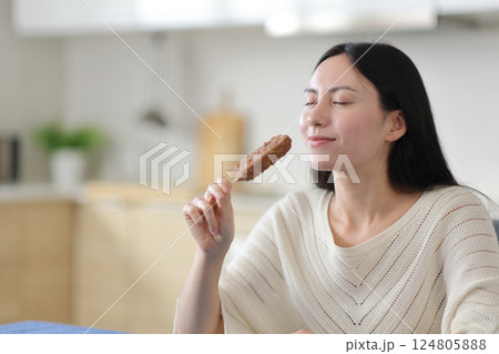 Asian woman enjoying ready to eat ice cream 124805888