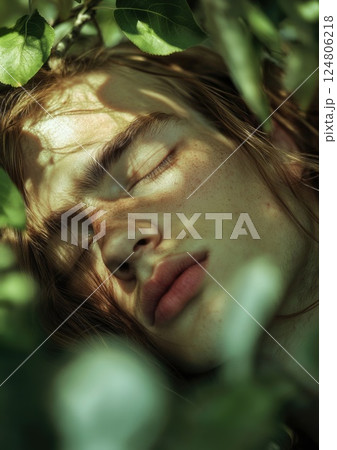 Male model with long hair sleeping in the branches of tree. 124806218