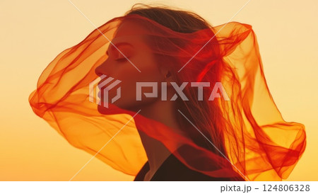Beautiful woman with orange hair translucent flowing fabric blowing in the wind. 124806328