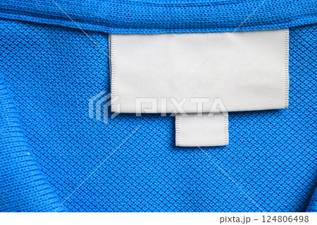 Blank white laundry care clothes label on blue shirt fabric texture background 124806498