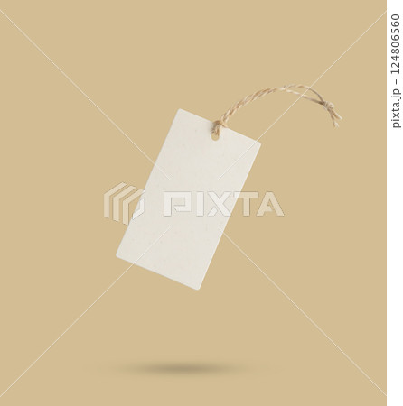 Blank price tag tied with string isolated on beige background Blank price tag tied with string isolated on beige background 124806560