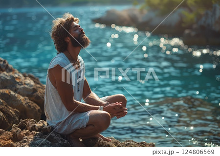 Meditation on the edge. Photo of a meditating human on the edge of a high cliff. Merging with the elements, the meditator finds harmony on the edge. Close-up view. Meditation on the edge. Photo of a meditating human on the edge of a high cliff. Merging with the elements, the meditator finds harmony on the edge. Close-up view. 124806569