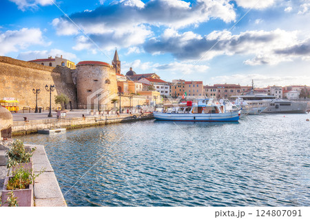 Unbelivable summer view of the Alghero Marina yacht port at the Gulf of Alghero with anchored sailboats. 124807091