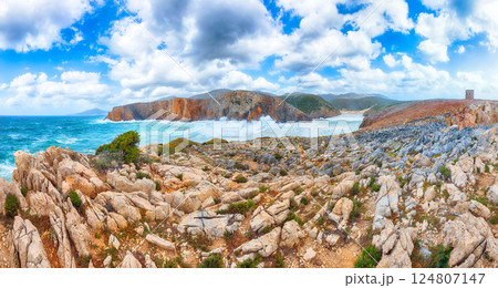 Attractive view of cliffs in valley Cala Domestica with old tower and storm on the sea Attractive view of cliffs in valley Cala Domestica with old tower and storm on the sea 124807147