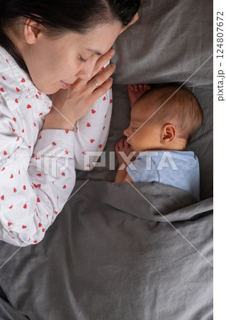 Newborn Baby Resting on mother tummy 124807672
